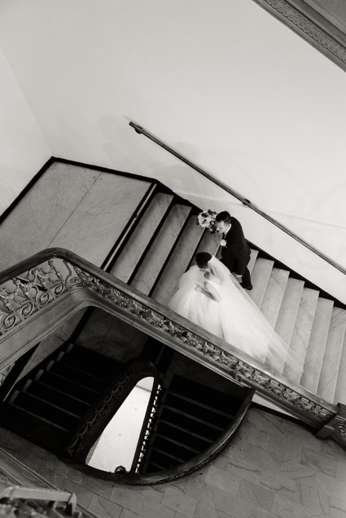 Photo of bride and groom in stairwell by Remo Fioroni, Los Angeles Wedding