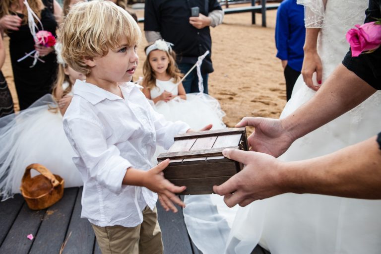 Child brings the rings to the groom