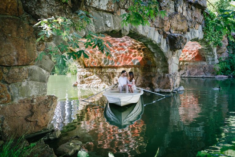 Couple in boats at Stowe Lake during an engagement photo shoot.