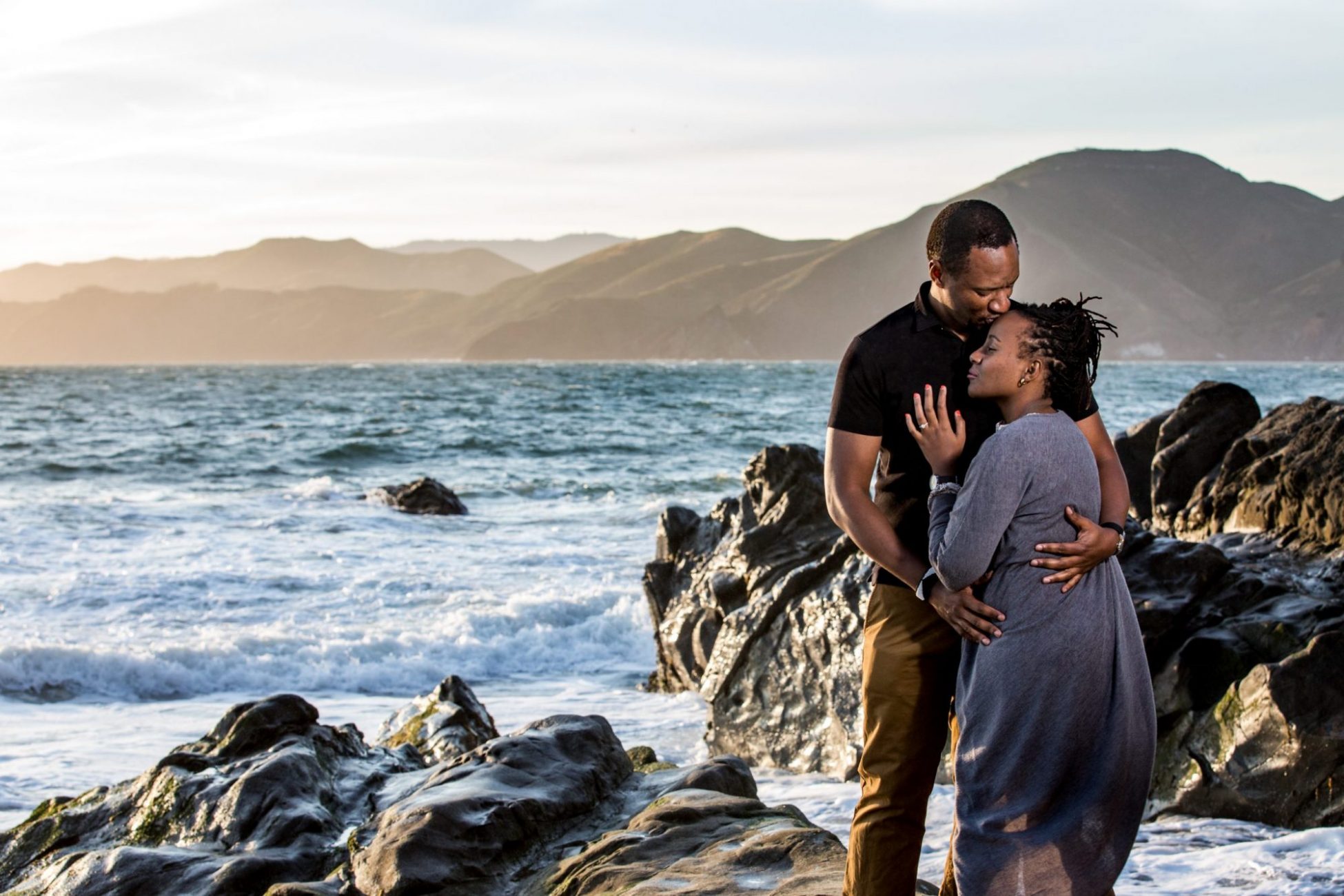 Couple embraces at Baker Beach Cliffs